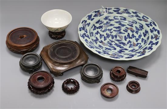 A Chinese underglaze blue and copper red dish, a bowl and various wood stands